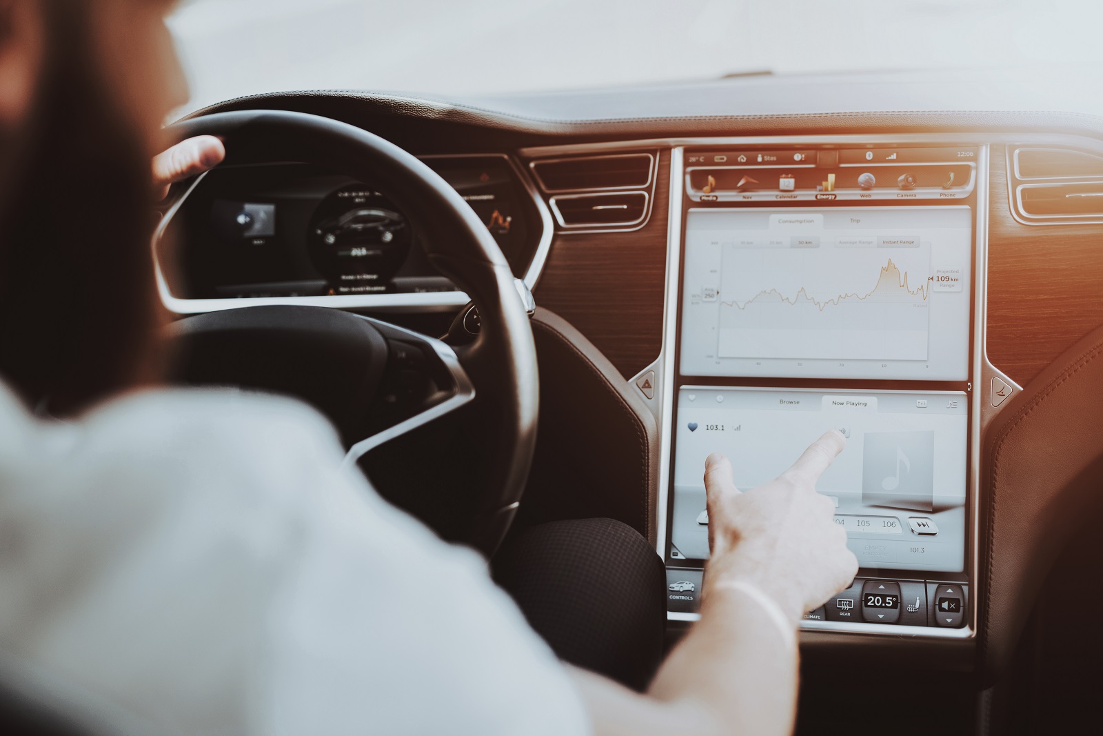 Man In A Tesla Car. Behind The Wheel Concept.