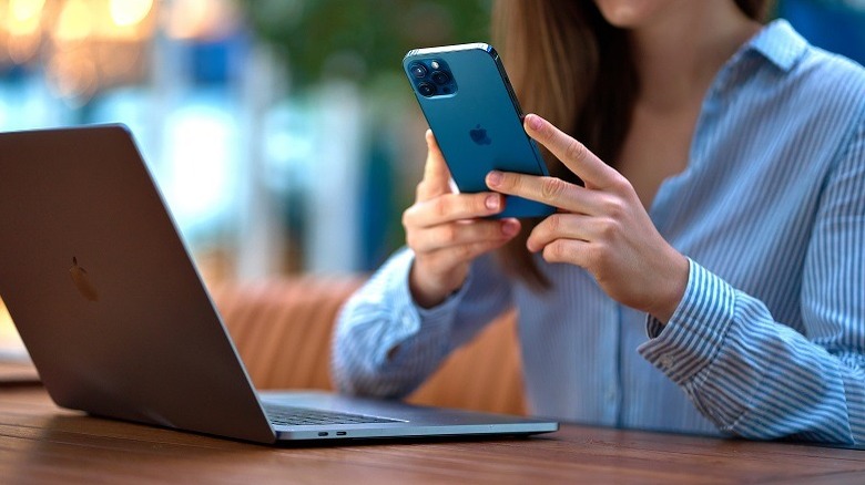woman using iphone and macbook