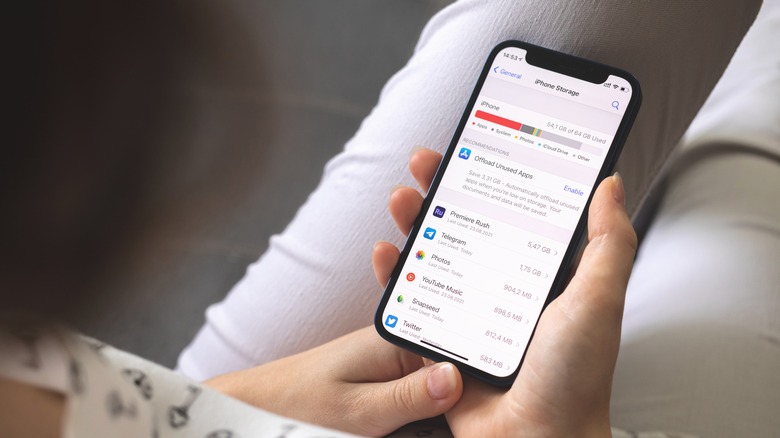 woman opening iPhone storage menu