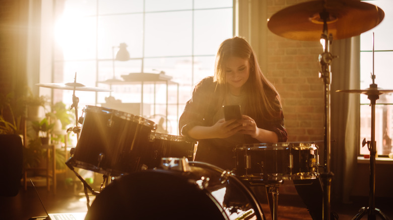 girl playing drum set