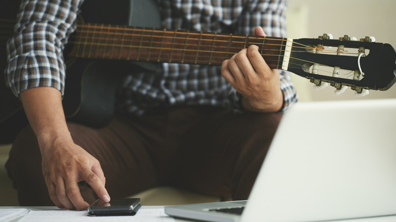 boy learning guitar with app