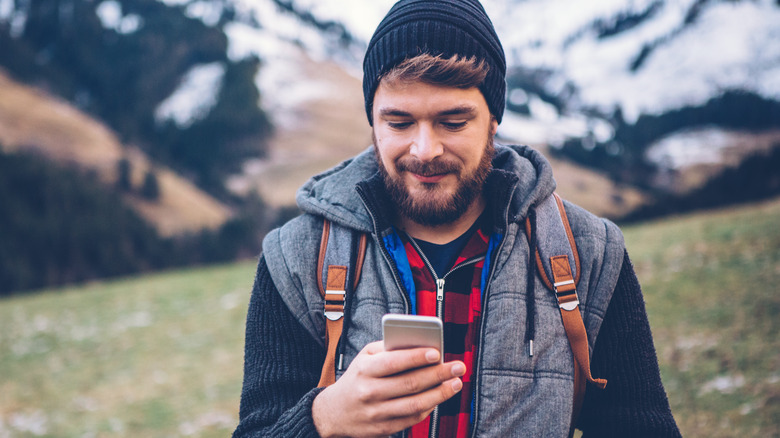 Man on hike with iPhone