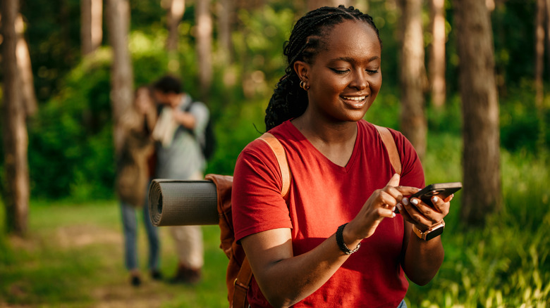 girl using iphone while hiking