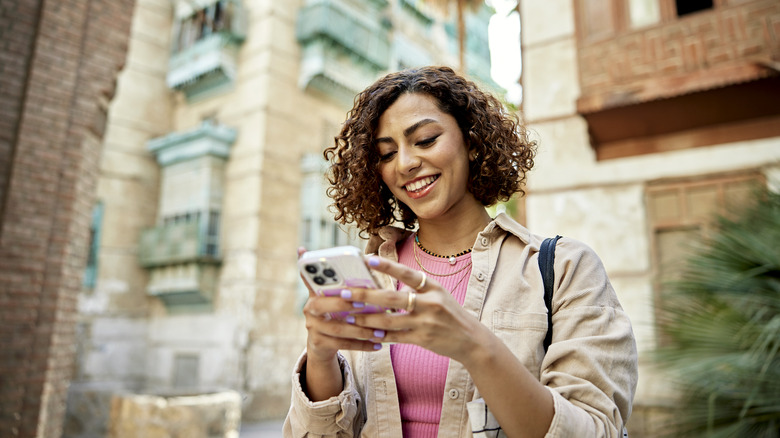 woman using iphone on vacation