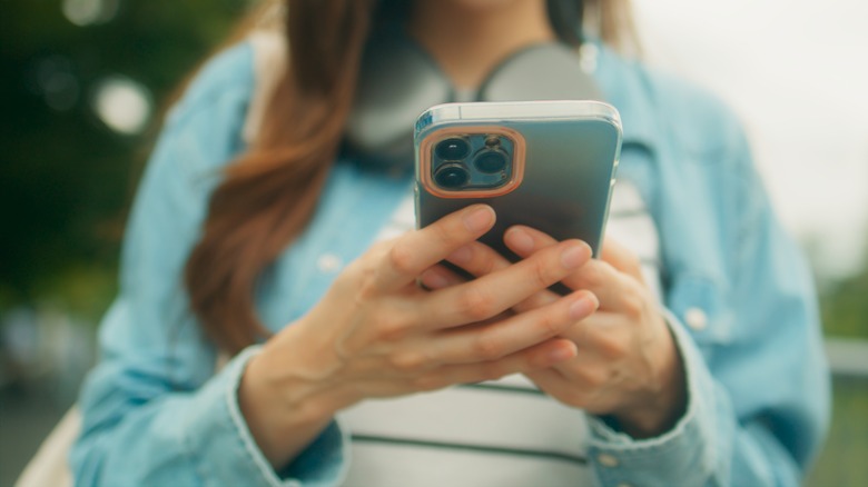 woman using iphone outdoors