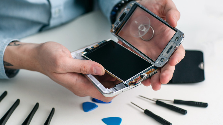 Person disassembling smartphone