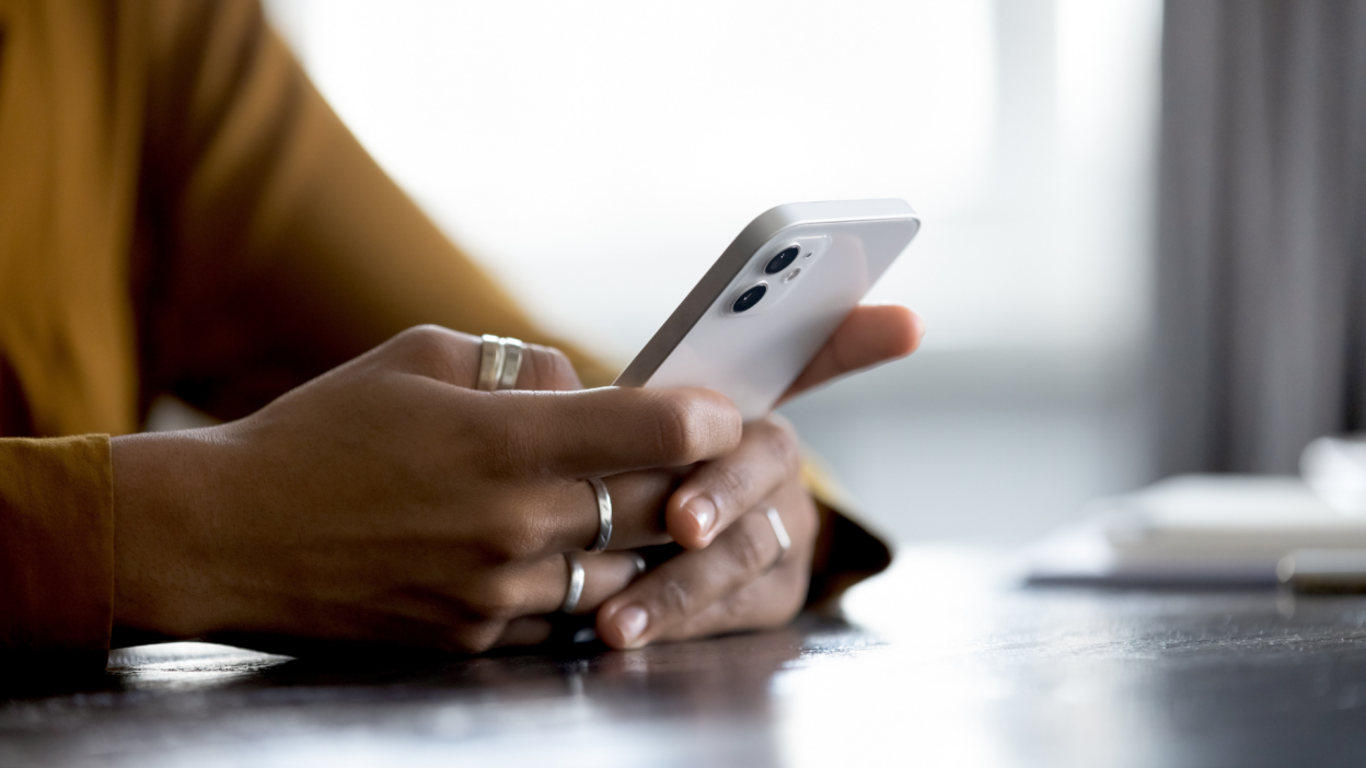 woman typing on an iphone