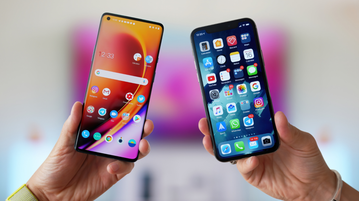 Hands holding an Android phone and iPhone side by side