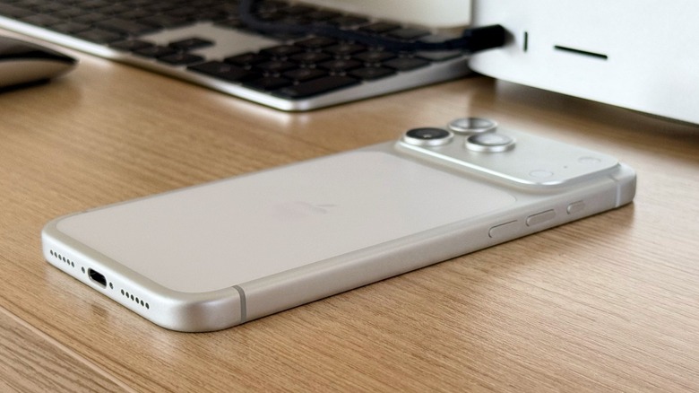 An iPhone 17 Pro facing down on a desk.