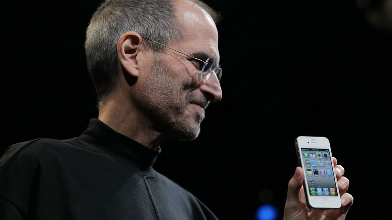 Steve Jobs holds the new iPhone 4 after he delivered the opening keynote address at the 2010 Apple World Wide Developers conference on June 7, 2010, in San Francisco, California.