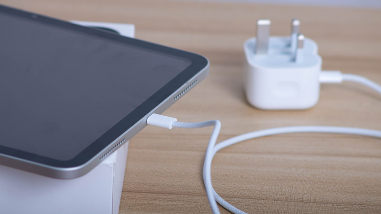 Apple iPad 11th Generation connected to charging cable