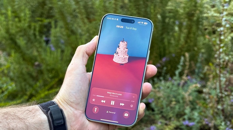 A hand holding an iPhone