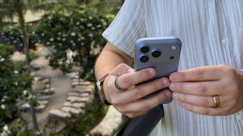 iPhone 18 Pro being held in both hands and used