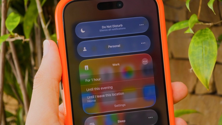 iPhone Control Center showing some of the default Focus modes: Do Not Disturb, Personal, Work and Sleep.