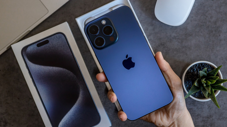 The iPhone 15 Pro Max, featuring a titanium chassis, in hand.